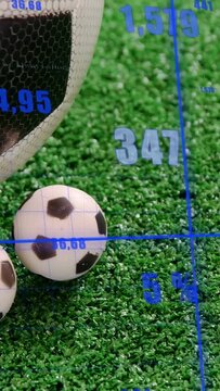 Vertical video: Camera panning causing soccer balls entering while HUD showing stats on turf