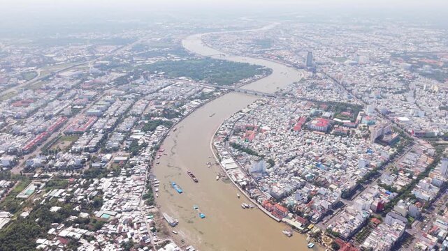 Above Perspective Of Mekong And Urban Area. Aerial Shot Capturing River Scenery And City Skyline Together. View From Above Showing River Winding Through City With Picturesque Surroundings