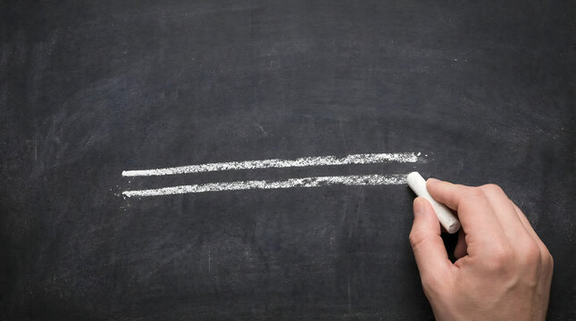A hand draws two parallel lines on a black chalkboard symbolizing an equals sign