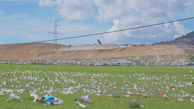 Massive Landfill with Plastic Littered Green Field