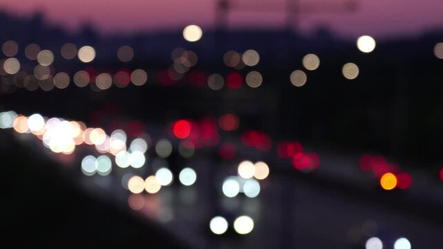 Beautiful colorful bokeh of car headlights and tail lights on a busy city highway at night