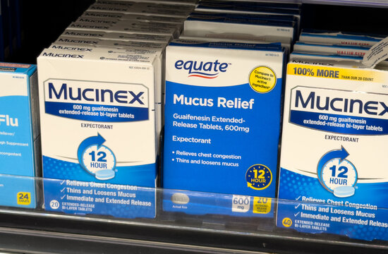 Mucinex and Equate Mucus Relief Expectorant Medicine on Pharmacy Shelf