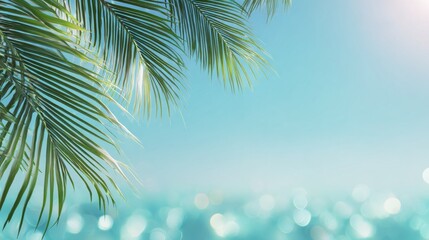 Obraz premium Tropical palm leaves over turquoise ocean with sunny bokeh effect