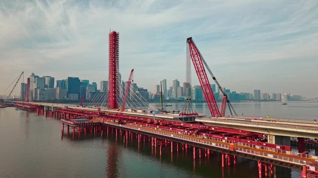Aerial view of cranes and construction equipment are working to dismantle an old cable stayed bridge.