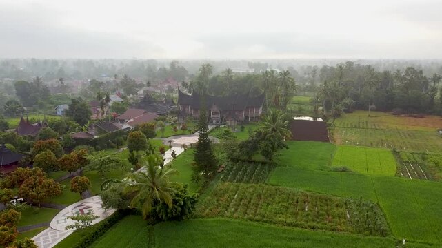rural landscape in the morning with the traditional house of the Minangkabau tribe, called the Rumah Gadang, in West Sumatra, Indonesia