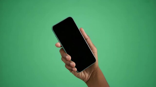 Hand Holding Modern Black Smartphone on Green Screen Chroma Key Background 4K