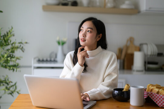 Young Asian woman contemplating new ideas at home