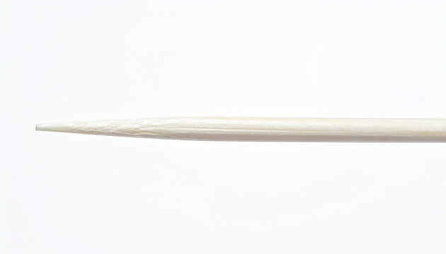 Extreme close-up of the sharp pointed tip of a wooden toothpick