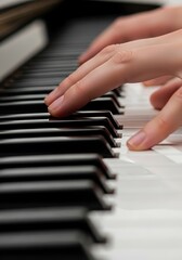 Obraz premium Close up of hands playing the piano keyboard with focus on fingers