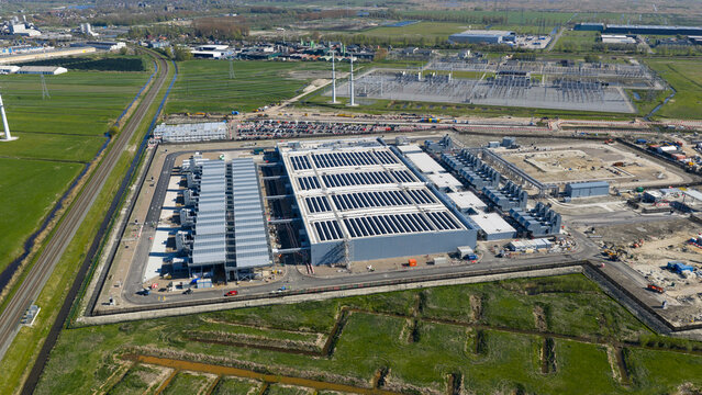 Aerial view of Datacenter Westpoort featuring solar panels on rooftops and surrounding green fields in Groningen, Groningen, Netherlands.