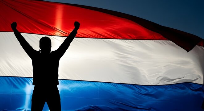 Man holding a dutch flag in the wind