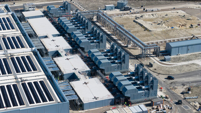 Aerial view of Datacenter Westpoort featuring solar panels on the roof, industrial cooling systems, and complex infrastructure in Groningen, Groningen, Netherlands.