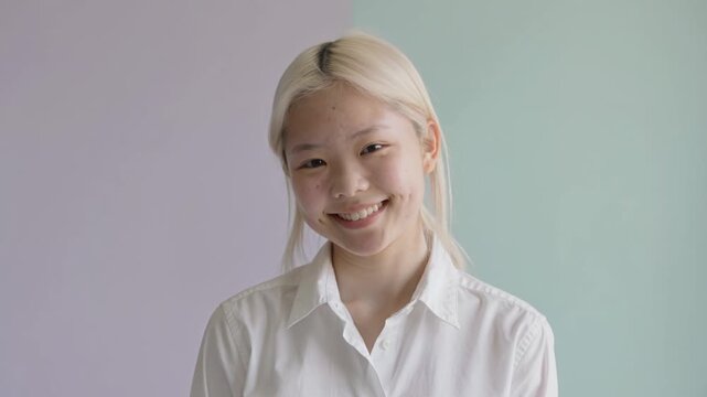 Happy Young East Asian Woman with Blonde Hair Smiling