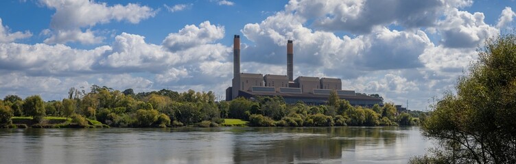 Fototapeta premium Huntly Power station, A large coal-fired power station generates electricity, seen across the Waikato river in New Zealand. The plant provides energy to the region.