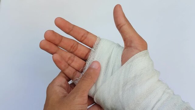 Hand wrapped in white medical bandage, first aid for injury, wound care and health recovery concept