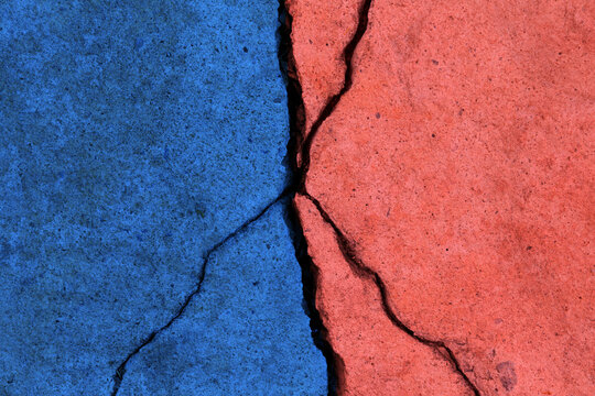 Cracked concrete surface in two colors, Conflict and divisio