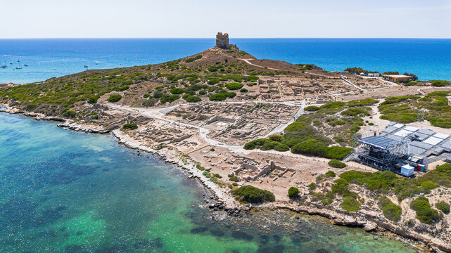 Aerial view of the ancient archaeological site of Tharros with Roman columns and ruins overlooking the sea, Sinis peninsula, Sardinia, Italy