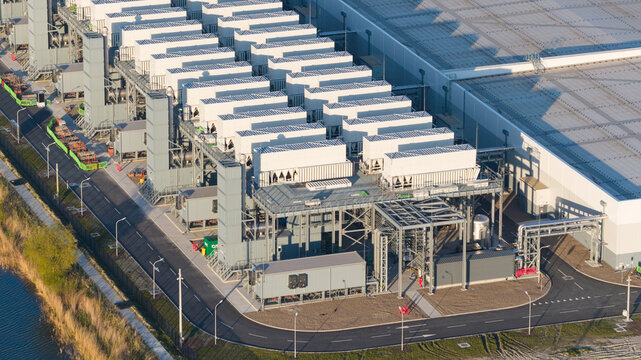 Aerial view of the Google Data Center featuring rows of cooling units and industrial infrastructure under bright sunlight in Eemshaven, Groningen, Netherlands.