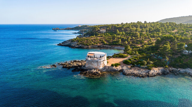 Aerial view of the Torre del Lazzaretto (Torre di Capo Galera), a historic coastal watchtower on a rocky promontory near Alghero, Sardinia, Italy