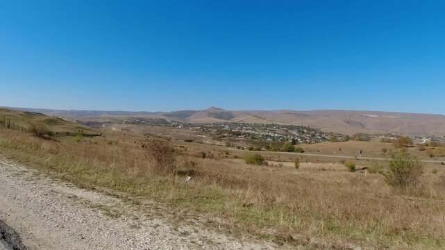 Roadside rolling hills POV view from car at road. Scenic view of nature countryside from the moving car window.