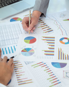Businesspeople evaluate project efficiency and financial figures with business team for marketing research and business strategy plan.