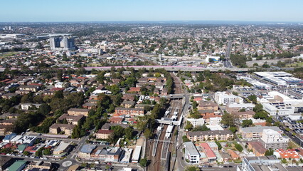 Obraz premium Aerial view of suburbs commercial district and train station