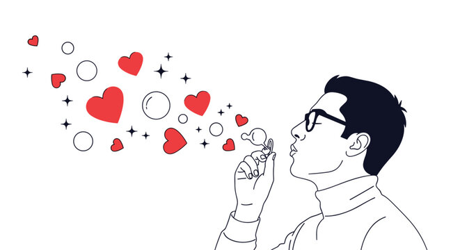 Man wearing glasses blows into a wand to create bubbles that turn into red hearts against a white background representing spreading love.