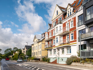 Obraz premium Apartment buildings and houses along Prieser Strand street in Friedrichsort town, Kiel, Schleswig-Holstein, Northern Germany