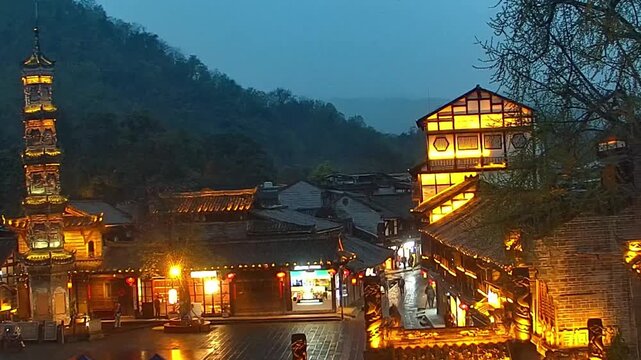 Dujiangyan, Sichuan/China - April 26 2026: Scenic view of the historic ancient town street featuring traditional Sichuan architecture and an ornate stone pagoda illuminated at night.