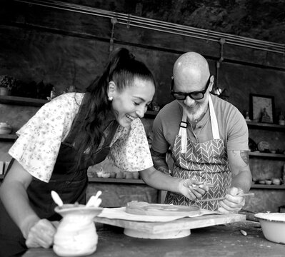 A happy couple makes ceramic plates in a workshop