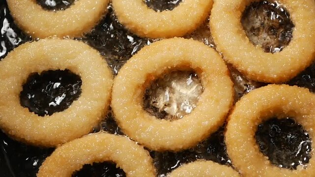 top view of frying onion ring on a cooking pan 