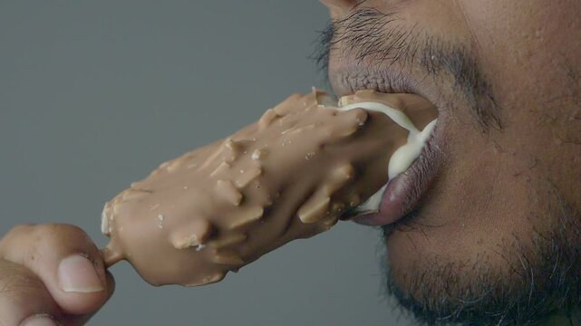 Enjoying a chocolate ice cream bar on a hot day