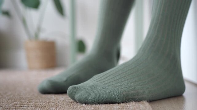 Discovering green socks on a floor mat