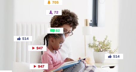 Reading woman wearing glasses holding child in pink top, sharing book on bed with social icons © vectorfusionart