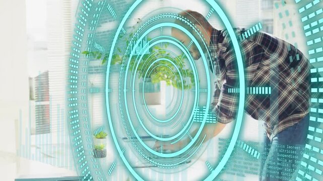 Turquoise HUD ringing, man leaning over laptop, working with expanding tech data rings for workflow