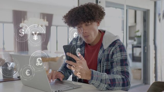 Man tapping phone and typing on laptop, causing currency symbols expanding while tracking finance
