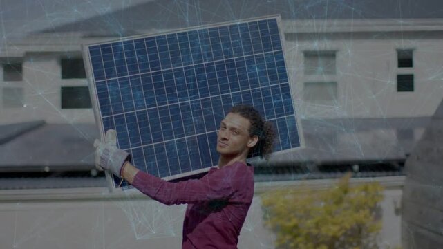 Installer starting by holding solar panel at chest, lifting onto shoulder for rooftop installation