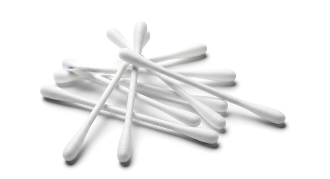 Pile of cotton swabs on a white surface for hygiene.