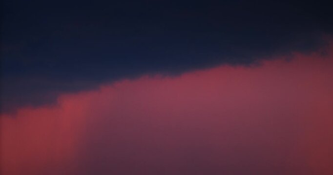 Rain clouds at sunset Time lapse.Dark Clouds Above a Fiery Gradient Sky at Sunset