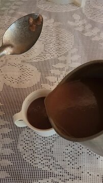 Pouring Hot Red Corn Atole into a Cup