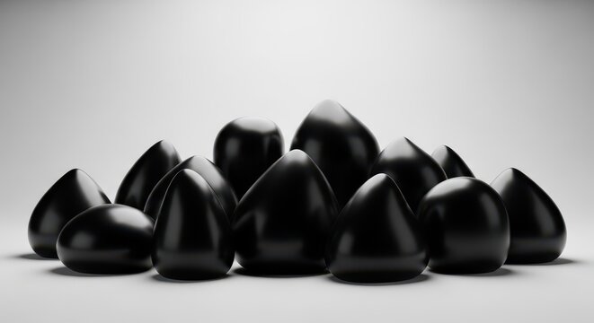 A collection of polished black geometric objects with shiny surfaces arranged together
