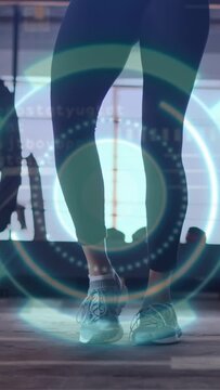 Vertical video: Woman weight-shifting and walking in gym, HUD analyzing heel-toe gait for training
