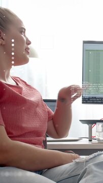 Vertical video: Woman seeing ping, leaning, pointing sheet while tech overlay marking rows