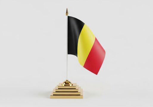 Flag of belgium, national symbol of the country, 3d render of the belgian flag on a gold desk stand isolated on white background