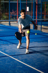 Obraz premium Athlete competing in padel court hitting ball