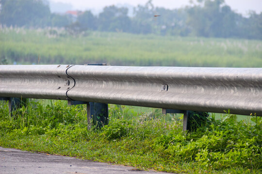 Metal guardrail lines a quiet rural road