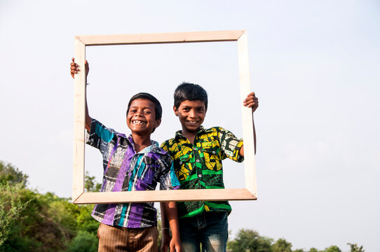 Rural boy enjoying together in the field, India.