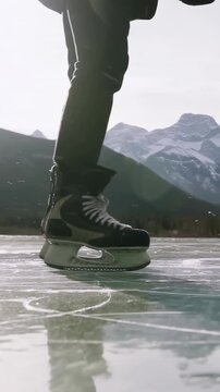 Vertical video: Shifting weight, partner joining, one in coat planting blades for leisure on ice
