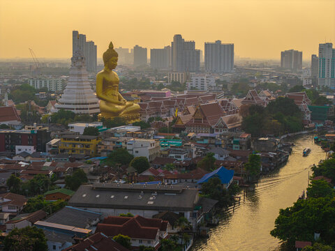 Aerial view Phra Buddha Dhammakaya Thep Mongkol Wat Paknam temple sunset light sky with modern office building