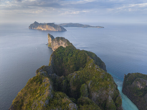 Aerial view of Phi Phi Islands featuring steep limestone cliffs covered in lush green vegetation surrounded by the turquoise sea in Mueang Krabi District, Krabi, Thailand.